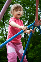 Fototapeta na wymiar Little girl on pipes on playground