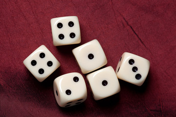 dice on red fabric