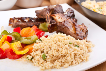 barbecue spare ribs with vegetables and couscous