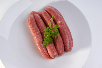 some raw beef sausages on a timber board