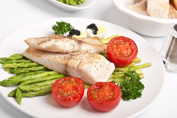 healthy fish fillet with asparagus and tomatoes