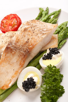 healthy fish fillet with asparagus and eggs with caviar