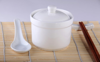 Close-up of  some Chinese utensils: bowl, soup spoon and chopsti
