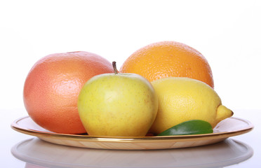 Fresh useful fruits on mirror table