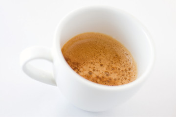 Coffee cup on white background with shallow depth of field