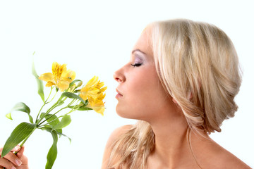 Pretty woman smelling a flower