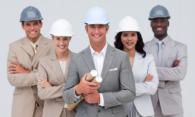 Architectural team smiling at the camera with hard hats