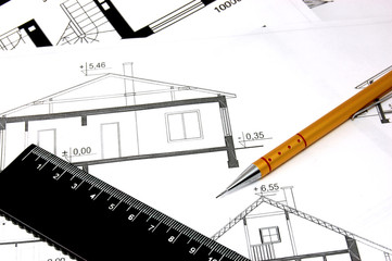Blueprints and drawings of house with pencil and straightedge