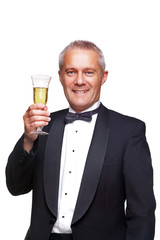 Man in tuxedo toasting with champagne.