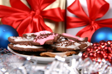 Plate of christmas cookies with gifts in the background