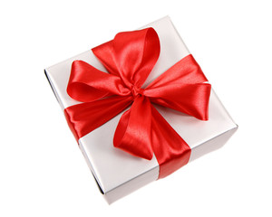 Gift in silver wrapping with red bow isolated on white