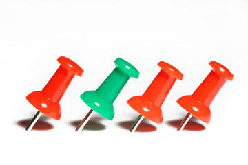 red and green pushpins macro, isolated on white