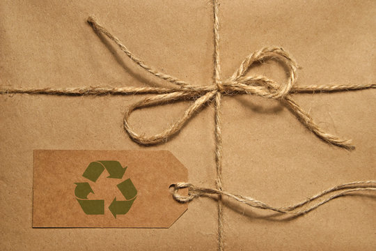 Brown shipping parcel tied with twine and tag for copy space