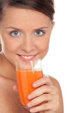 Young woman with glass of carrot juice