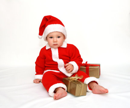 12 months old baby boy dressed in santa claus costume