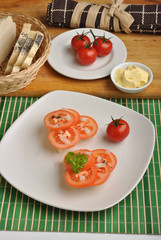 half bread roll with organic tomato slices