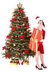 Christmas girl in santa hat and fir tree with red gift box.