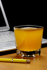 Orange juice,laptop and  pen