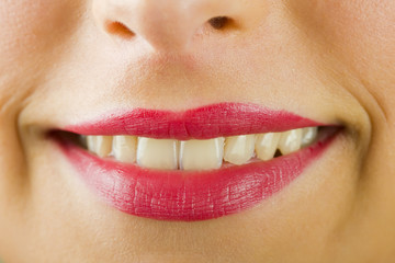 Fototapeta premium Smiling lips with lipstick