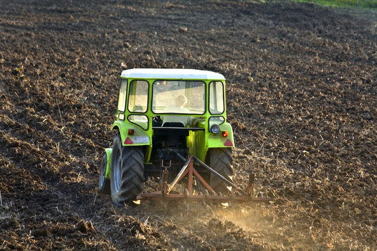 Tractor subsoiling field at fall season