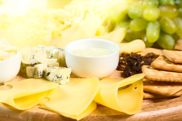 Various types of cheese on wooden platter