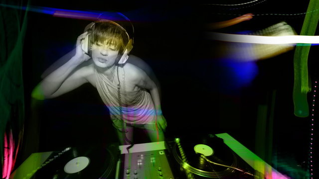 beautiful young female dj, behind the decks at a club