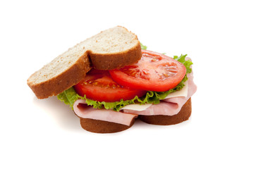 A ham sandwich on wheat on a white background