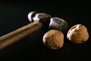 Two walnuts and old aged hammer
