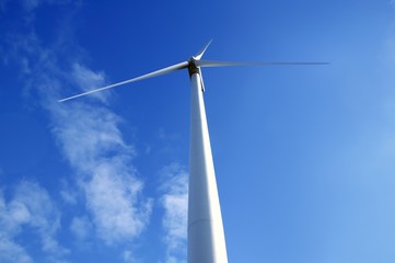 Fototapeta premium Electric wind mill viewed from the floor over blue sky