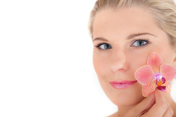 Young healthy woman with beautiful pure skin and flower