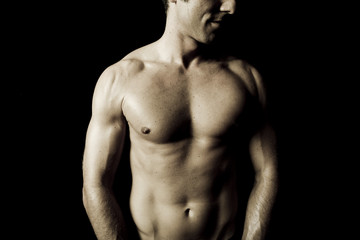muscular male torso on black background