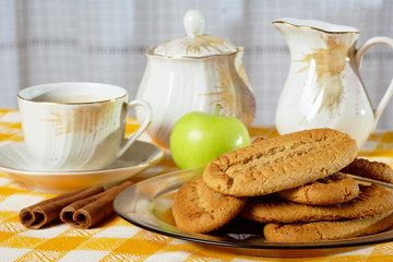 Breakfast with cinnamon cookies, coffee and green apple