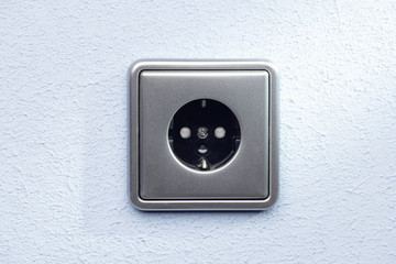 silver socket on a blue wall
