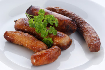pork black pepper sausages on a white plate
