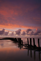Romantic and dramatic red sunset over the Wadden sea - 18599523