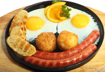 Smiling fried eggs with sausages
