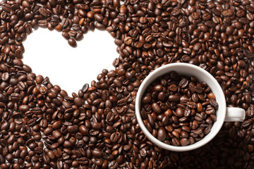 Cup on coffee beans with white heart shape for your text