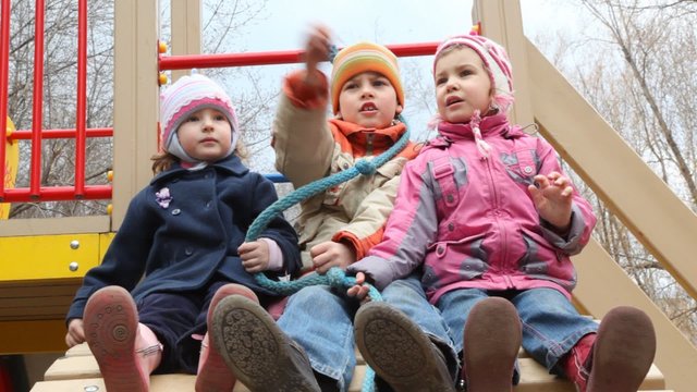 3 kids playing on playground
