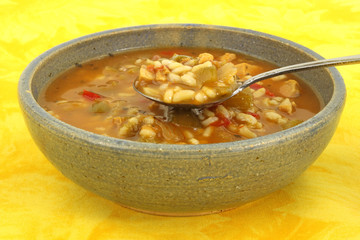 Chicken soup in old bowl with spoon