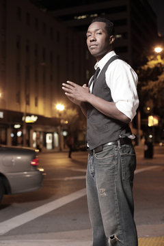 Black man in the city at night