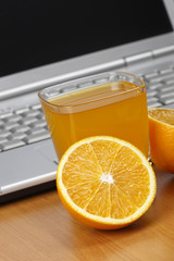 Oranges, juice and laptop