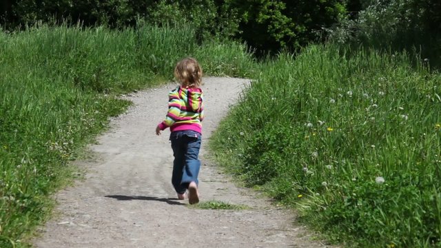 Little girl running by country road