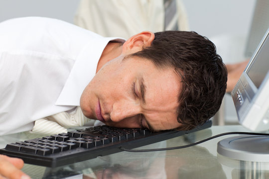 Businessman Sleeping On The Keyboard In The Office