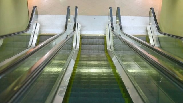 camera moving down on escalator