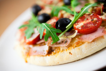 Pizza with cherry tomatoes and black olives