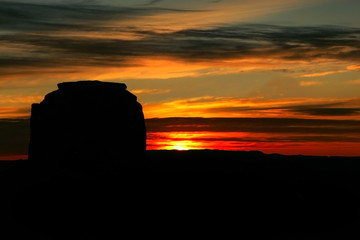 Dramatic sunrise with monument valley silhouetted.