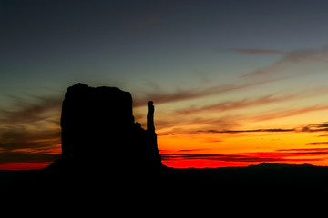 Landscape of a dramatic sunrise with rock formations silhouetted