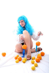 Fototapeta na wymiar blue hairs girl with oranges and lemons