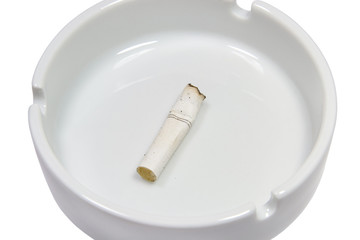 Closeup of a cigarette stub in a white ash-tray