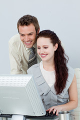 Attractive business people using a computer